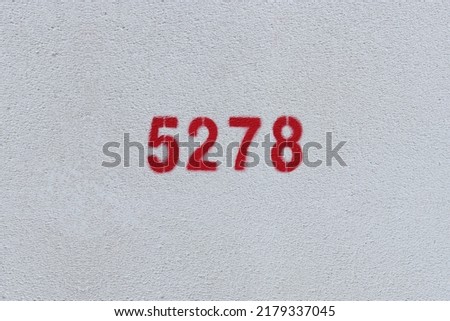 Red Number 5278 on the white wall. Spray paint.
