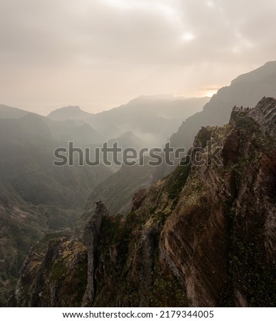 Travel in Madeira, mountain range at sunrise, people on viewpoint
