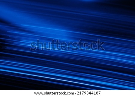 Blur neon glow. Luminous light flare. Cyber glare reflection. Defocused UV navy blue color streak rays motion on dark night black futuristic abstract background.