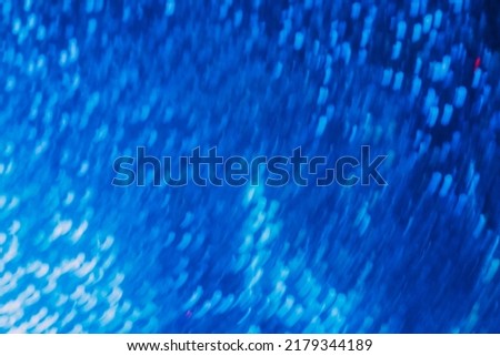 Bokeh neon glow. Fluorescent background. Futuristic radiance. Defocused luminous blue white color gradient light flare rays motion abstract texture.
