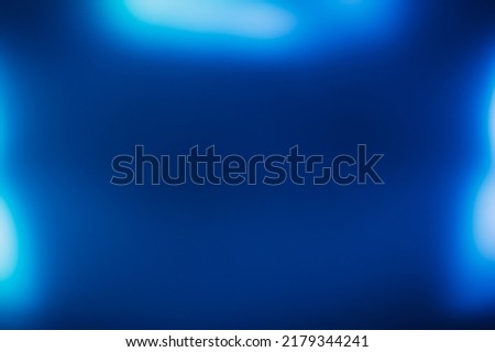 Blur neon glow. Bokeh light flare. Sci-Fi illumination flecks. Defocused navy blue color glare on dark futuristic ultraviolet presentation frame abstract copy space background.