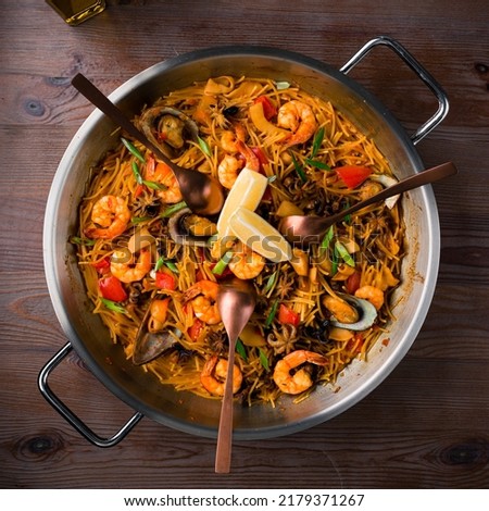 Fideua Spanish seafood dish. Spanish cuisine from Valencia. Sea food pasta dinner, Noodle paella. Typical Catalan dish made with noodles and seafood Royalty-Free Stock Photo #2179371267