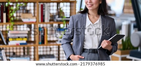 Young smiling business woman office employee or teacher standing holding digital tablet. Businesswoman leader, professional company executive manager using smart corporate technology. Close up banner Royalty-Free Stock Photo #2179376985