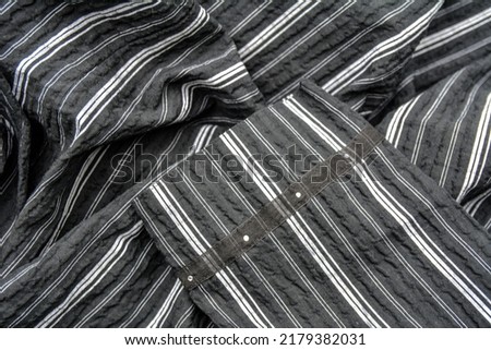 Elegant black and white silk with stripes, abstract background .