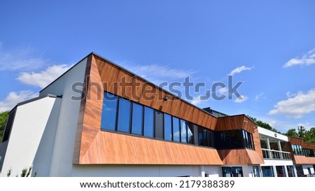 Office building with white aluminum composite panels. Facade wall made of glass and metal. Abstract modern business architecture. Royalty-Free Stock Photo #2179388389