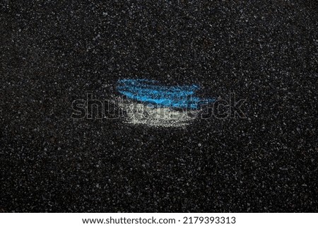 The flag of Ukraine is drawn in chalk on the asphalt. High quality photo