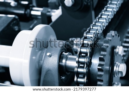 Gear chain drive shaft in conveyor belt is on production line. Timing chain of car, tensioners in engine. Industrial roller chain, technology. Team work, business industrial concept Royalty-Free Stock Photo #2179397277