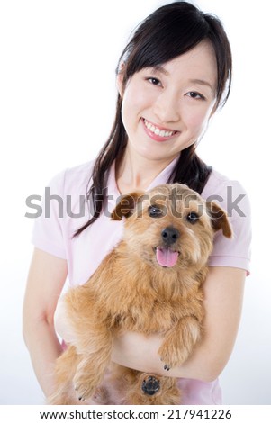 Young woman with Norfolk terrier dog, isolated on white background 