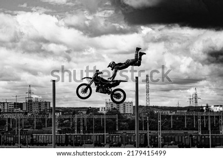 Stuntman on a bike performing a stunt jump in the air