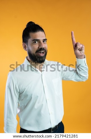 excited latin man pointing with background