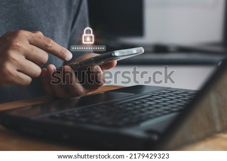 Asian businessman using the smart mobile phone to access on phone with laptop for validate password for biometric two steps authentication to unlock security, Business Technology security Concept Royalty-Free Stock Photo #2179429323