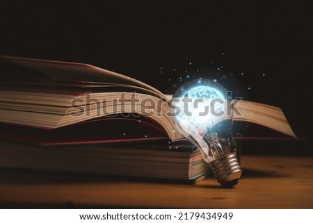 Virtual drawing of glowing blue brain with open book for knowledge study and education can make creative thinking idea concept. Royalty-Free Stock Photo #2179434949