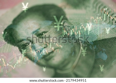 Closeup Mao Tse tung on Yuan banknote with stock market chart graph for currency exchange and global trade forex concept.
