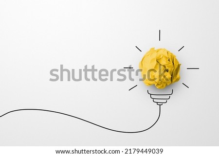 Creative thinking ideas and innovation concept. Paper scrap ball yellow colour with light bulb symbol on white background Royalty-Free Stock Photo #2179449039