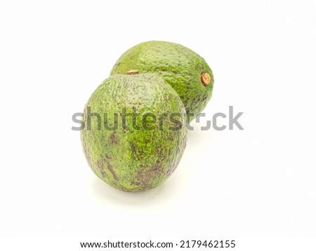 Avocados on a white background. Side view. Space for text. Healthy fruits concept