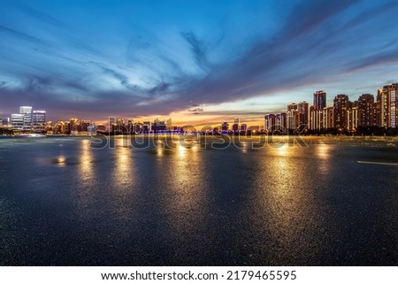Asphalt road and city skyline with modern building at night in Suzhou, China.  Royalty-Free Stock Photo #2179465595