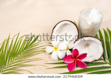 Coconut juice and coconut on white sand beach