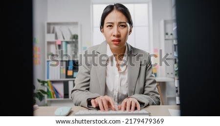 Young Asia businesswoman sitting on desk with laptop under stress from too much work in the office. Worker with deadline job shouting crazy work overwhelmed at office, Mental Health in the workplace. Royalty-Free Stock Photo #2179479369
