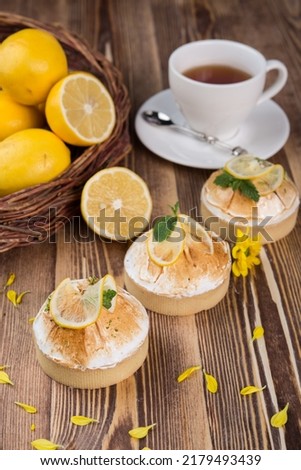 lemon tartlets on a wooden table, lemon meringue pie