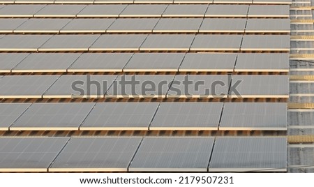 Solar panels installation on flat roof image for energy conservation presentation and report background.
