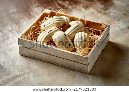 Cookies glazed with white chocolate in a box. Selective Focus. Noise in post-production