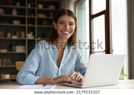 Workflow using modern wireless tech, self-employed businesslady portrait, career and professional ambitions concept. Young successful woman sit at workplace desk with laptop smile looking at camera