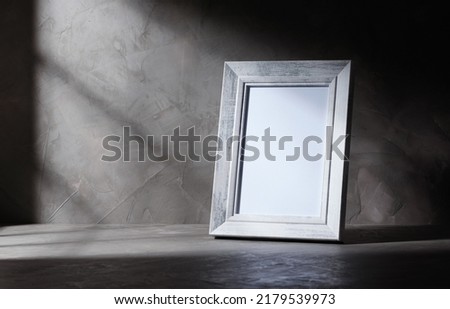 empty wooden white old style picture frame on concrete background with shadow window, copy space