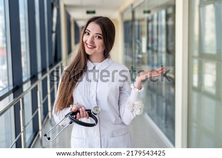 Portrait of smiling female doctor with cute friendly appearance in scrubs with stethoscope in hospital office. Woman portrait concept