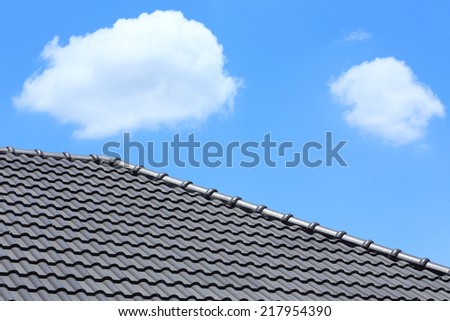 black tile roof on a new house with blue sky