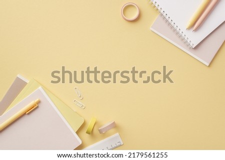 Back to school concept. Top view photo of stationery diaries pens ruler clips and adhesive tape on isolated pastel yellow background with copyspace