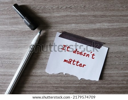 A pen on wood background with stick note written IT DOESN'T MATTER,  to tell someone you are not upset at what they have done, or tell yourself don't worry or never mind Royalty-Free Stock Photo #2179574709
