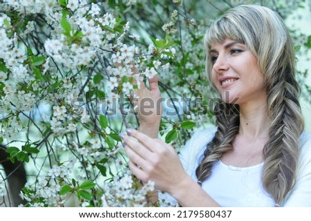 Portrait of beautiful smiling woman posing at park