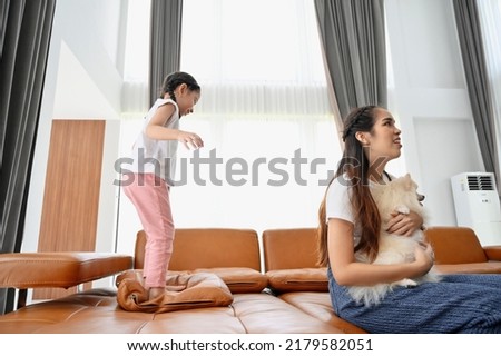Portrait of happy family with a dog having fun together at home.