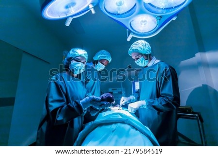 Team of surgeon doctors are performing heart surgery operation for patient from organ donor to save more life in the emergency surgical room Royalty-Free Stock Photo #2179584519