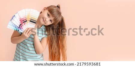 Little girl holding color palettes on pink background with space for text
