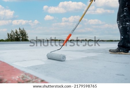 Hand painted gray flooring with paint rollers for waterproof, reinforcing net,Repairing waterproofing deck flooring. roof, Royalty-Free Stock Photo #2179598765