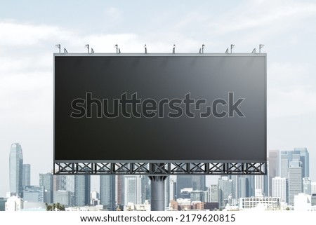 Blank black horizontal billboard on skyline background, front view. Mock up, advertising concept