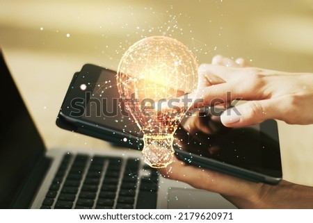 Creative idea concept with light bulb illustration and finger clicks on a digital tablet on background. Multiexposure