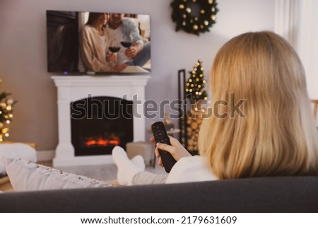Woman watching romantic movie on TV at home
