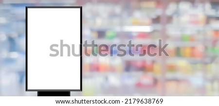 mockup white poster with black frame stand in front of blur department shopping mall  background for show or present promotion product concept