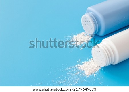 Spilled baby talcum powder in container. Kids skin care cosmetic Royalty-Free Stock Photo #2179649873