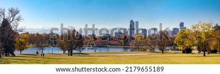 Panoramic view of downtown Denver Colorado from City Park in Fall with the front range mountains in the background