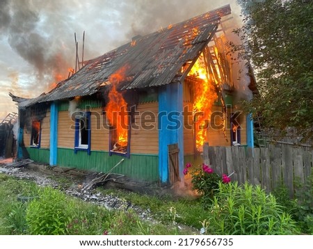 Fire of a private house in the village. The fire is spreading rapidly and has already spread to the roof.
