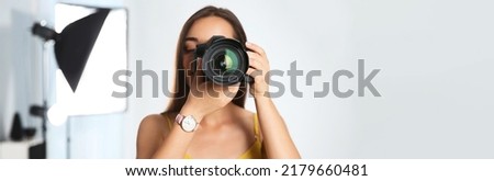 Professional photographer with camera in studio, space for text. Banner design