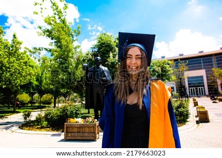beautiful graduated girl taking a photo