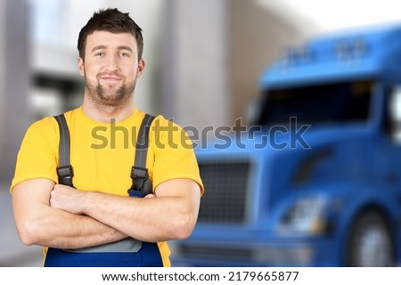 Portrait of confident truck driver on parking outdoor background