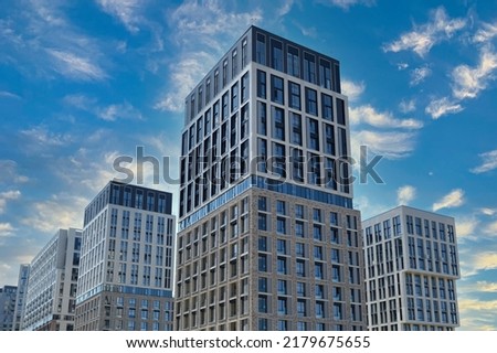 Exterior of a modern building house object with texture walls and windows. Luxury modern tall block of flats without balconies. Living apartments or office building. Real estate concept.
