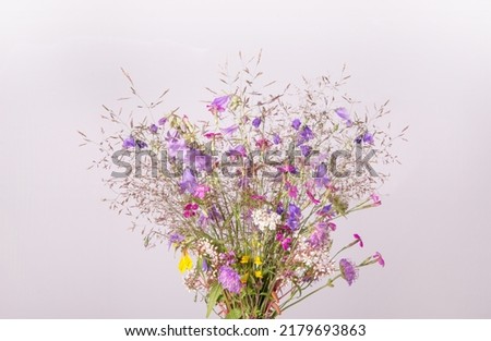 Festive bouquet of yellow and purple, blue wildflowers, herbs on gray background. Birthday, Mother's, Valentines, Women's, Wedding Day concept. Royalty-Free Stock Photo #2179693863