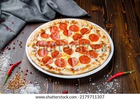Pepperoni pizza on plate on wooden table