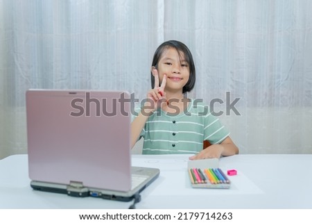 Children working and learning online in room of house